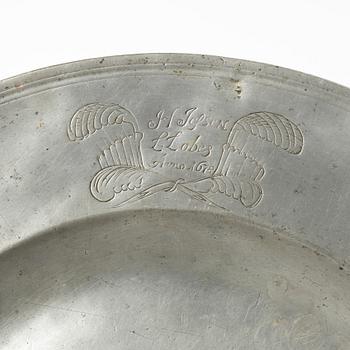 An English baroque pewter charger, dated 1672.