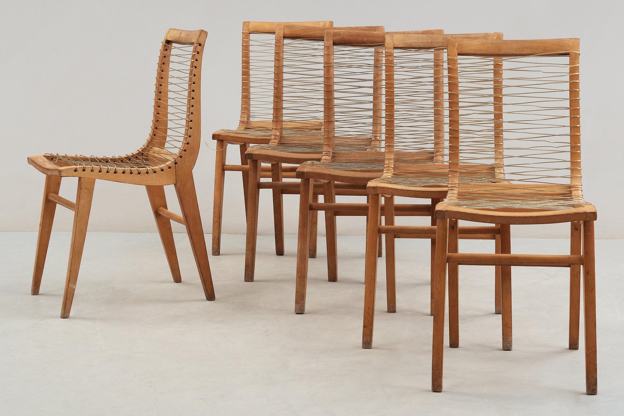 A Louis Sognot set of six ash, metal and rubber chairs, France 1950's.