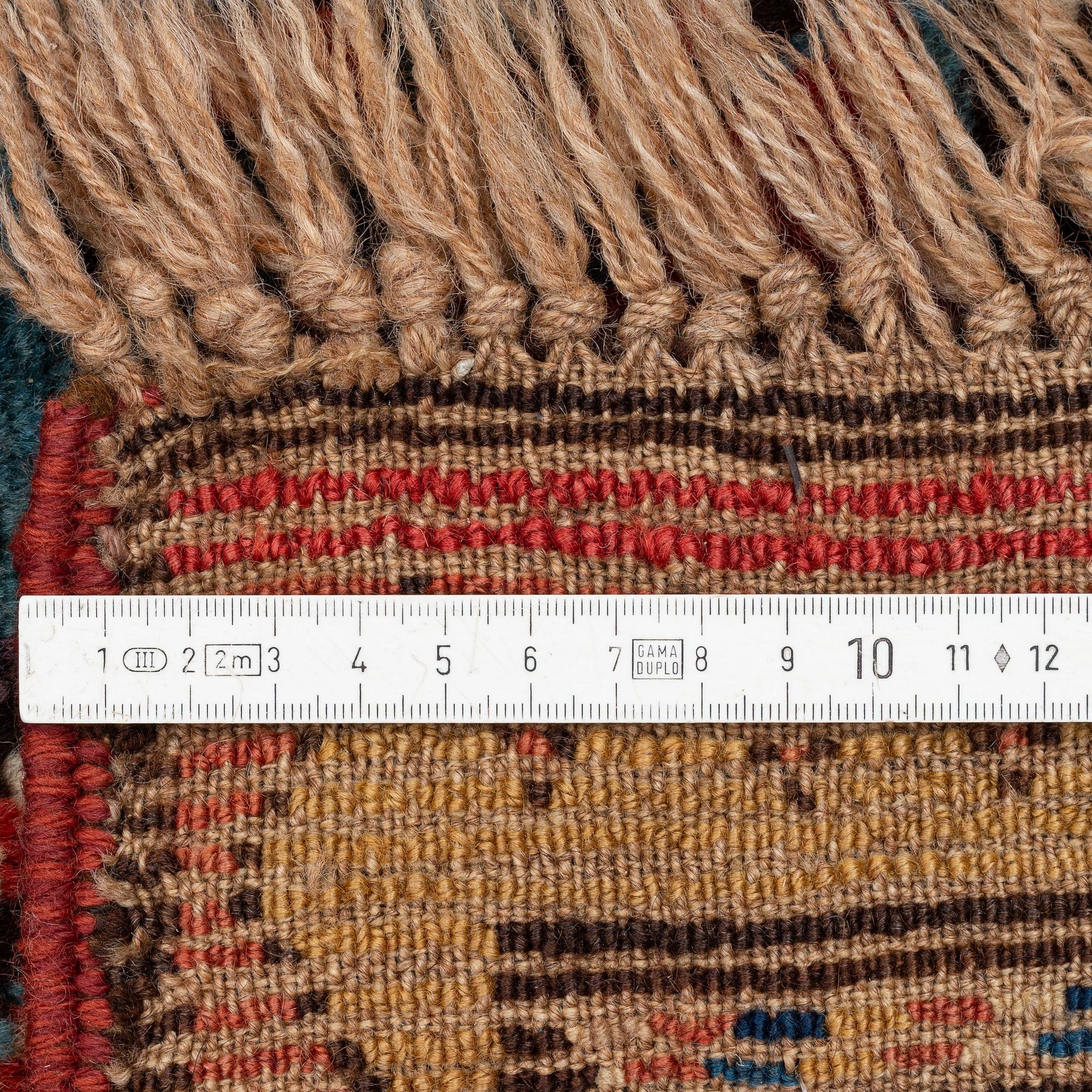 An antique Gendje rug, south Caucasus, c. 208 x 103 cm.