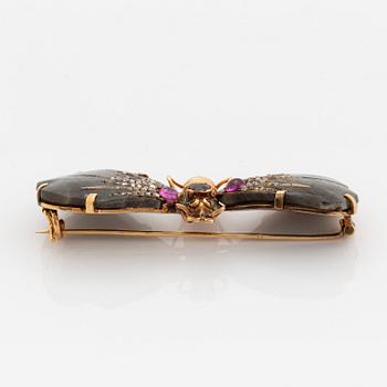 A butterfly brooch in 14K gold set with labradorite, rubies, rose-cut diamonds and garnets.