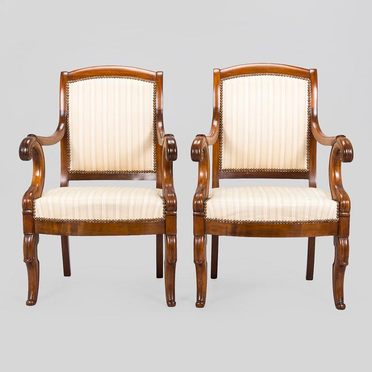 A pair of French open-arm chairs, first half of the 19th century.