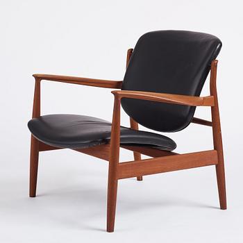 Finn Juhl, a teak and black leather 'model 136' easy chair, France & Daverkosen, Denmark 1950-60s.