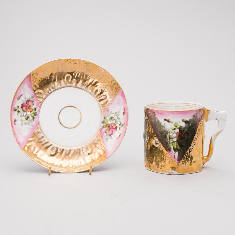 Two Russian porcelain cups, Kuznetsov, Dulevo 1864-1889 and Riga 1890-1910.