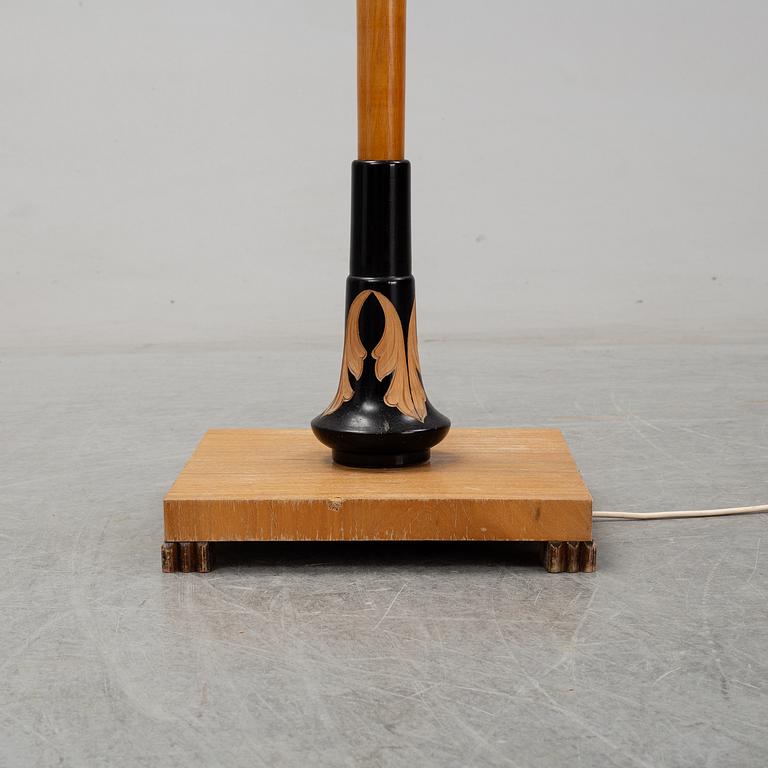 An elm floor light, mid 20th Century.