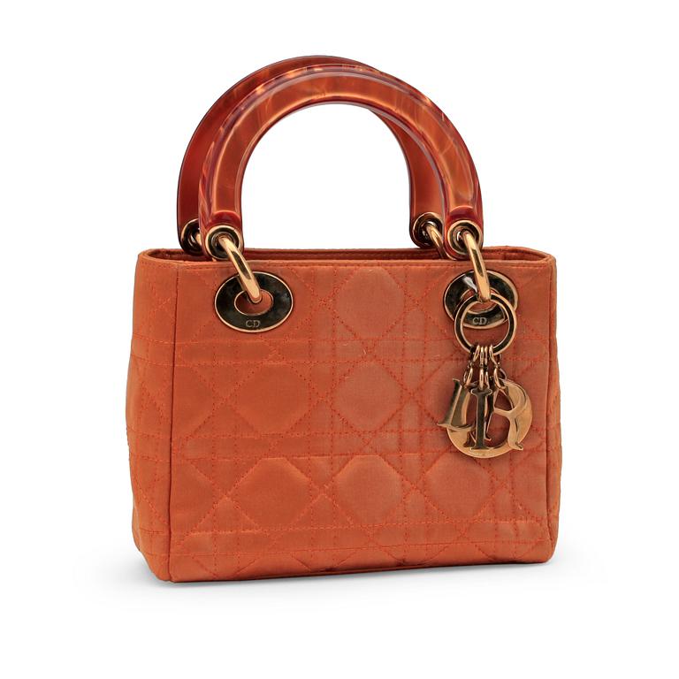 CHRISTIAN DIOR, an orange silk handbag.