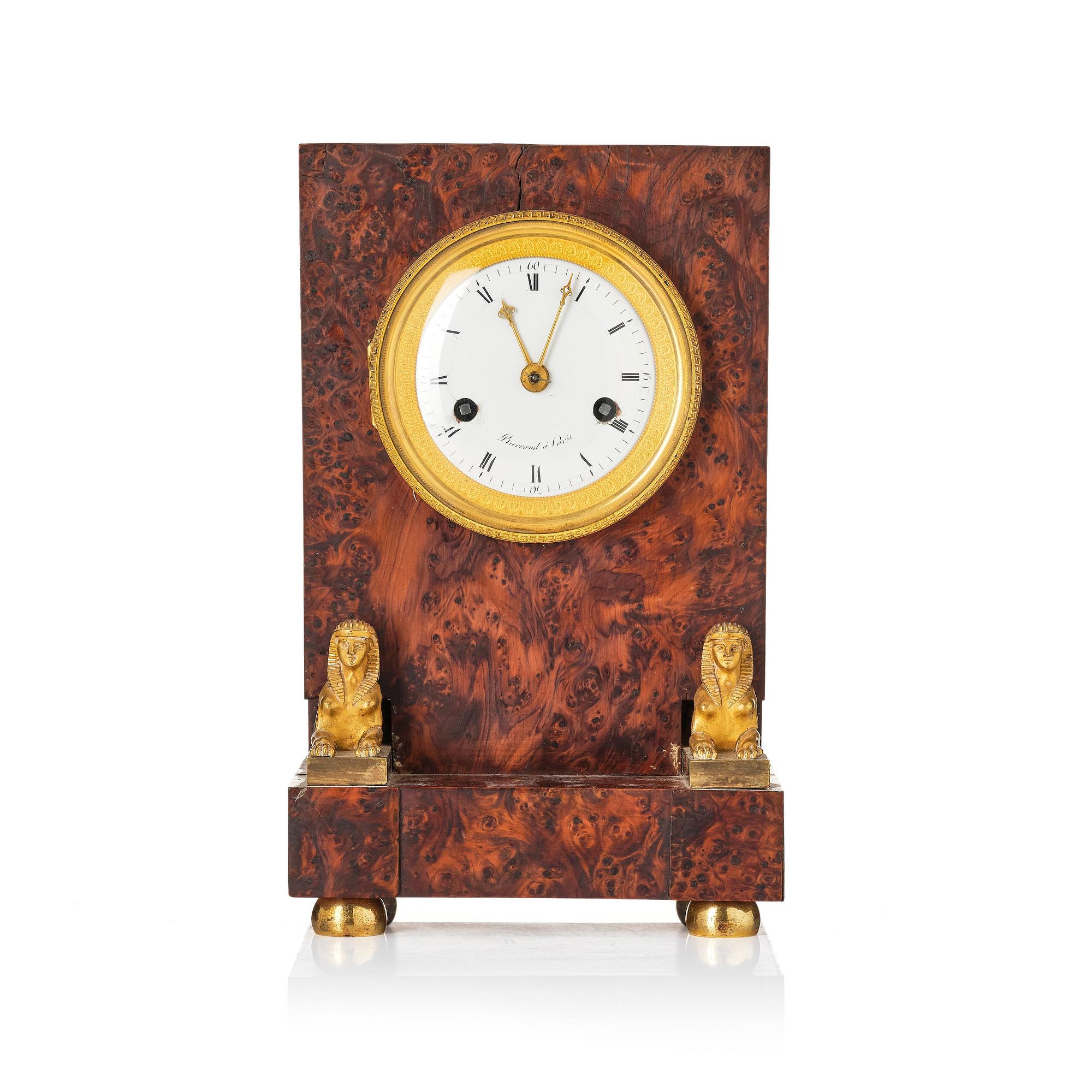 A French Empire burr-amboyna and ormolu mounted 'pendule borne' mantel clock by Barrand (master in Paris 1805-32).