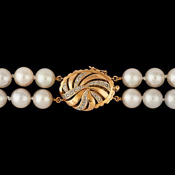 1224. A two strand cultured pearl necklace, 8.2 mm, clasp set with brilliant cut diamonds, total carat weight circa 0.20ct.