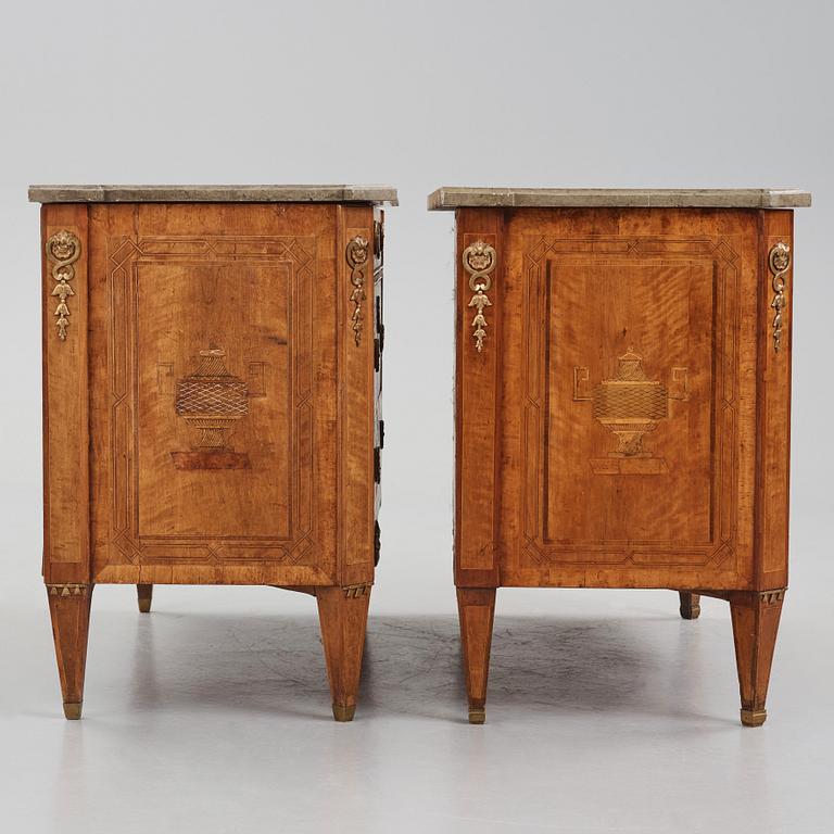 A matched pair of Gustavian ormolu-mounted limestone topped and marquetry commodes by C. Lindborg, late 18th century.