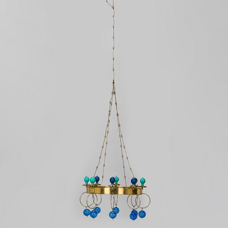 Kaija Aarikka, A 1960s/1970s brass mobile candelabra by Aarikka with candles by Timo Sarpaneva.