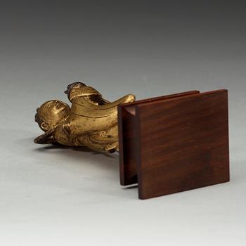 A gilt bronze figure of Longnü, Ming Dynasty, 17th century.