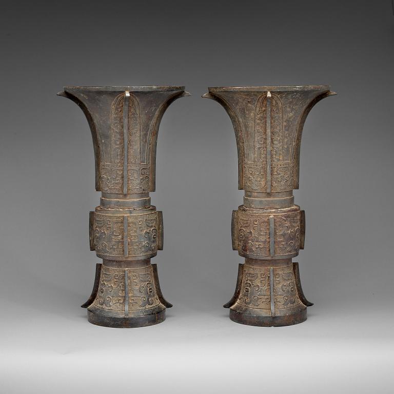 A pair of large archaistic shaped bronze Gu vases, Ming dynasty (1368-1644).