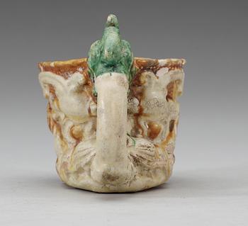 A green white and yellow glazed rhyton ewer, Tang dynasty (618-907).