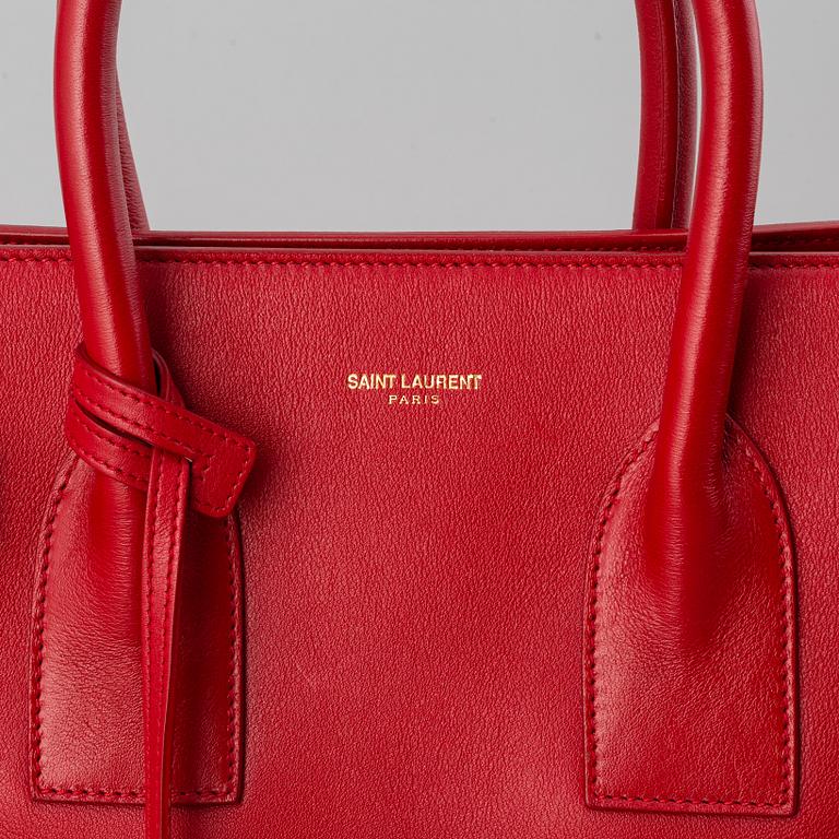 Saint Laurent, a red leather 'Sac du Jour Small' bag.