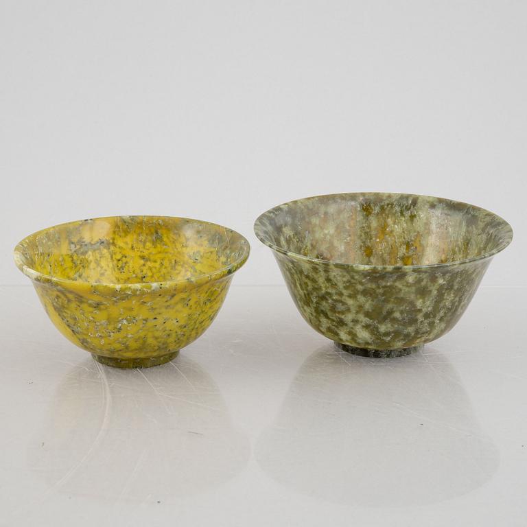 A group of ten Chinese spinach green stone bowls.