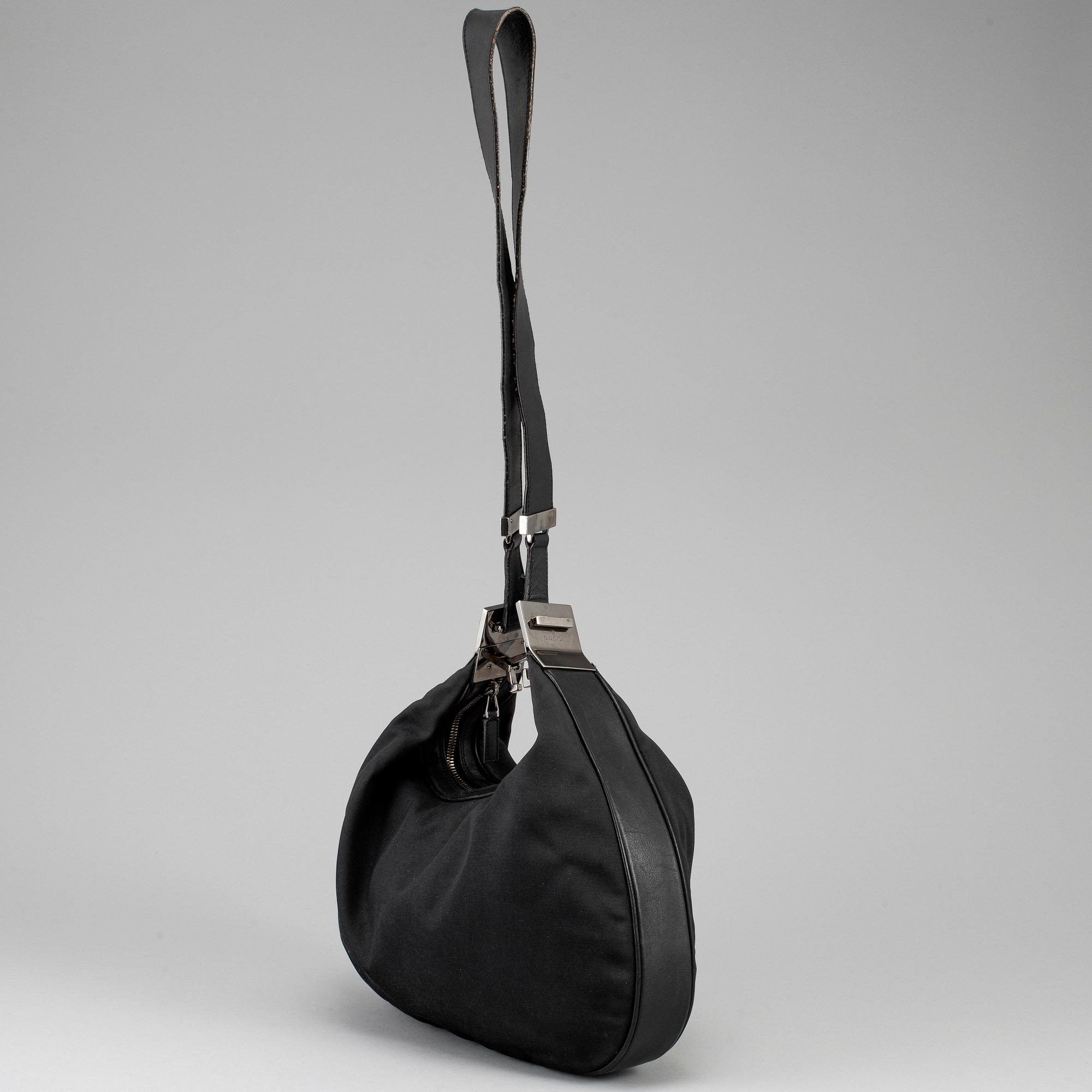 GUCCI, a canvas handbag.