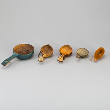 A set of five amongst others Sami cups made of birchwood and reindeer antlers.