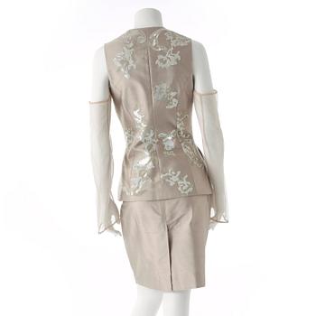 GIANFRANCO FERRÉ, a beige three-piece ensemble consisting of vest , trousers and skirt.