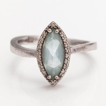 A 14K white gold ring with a topaz and diamonds ca. 0.12 ct in total. Faber art, Helsinki.