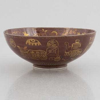A brown glazed bowl with gilded decoration of animals and antiques, Qing dynasty, 19th century.