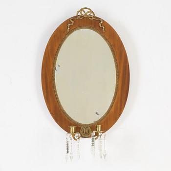 A mahogany veneered mirror sconce, Empire style, around 1900.