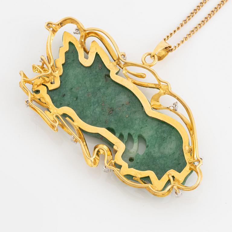 Pendant in gold with a carved green stone, adorned with brilliant-cut diamonds.