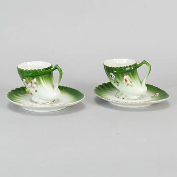 A pair of Russian porcelain cups and saucers, Kuznetsov, circa 1900.