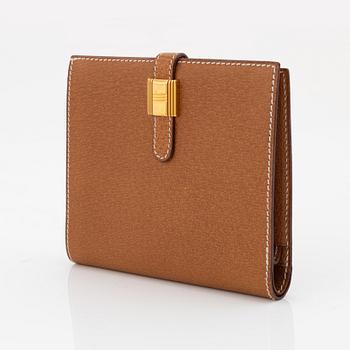 Hermès, a brown leather gold lock wallet.