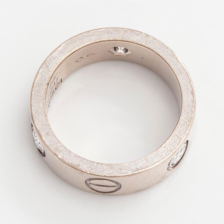 Cartier, an 18K white gold 'Love' ring with three brilliant-cut diamonds.