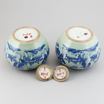 A pair of Chinese celadon glazed and blue and white jars with covers, 20th century.