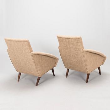 A pair of 1950s armchairs.