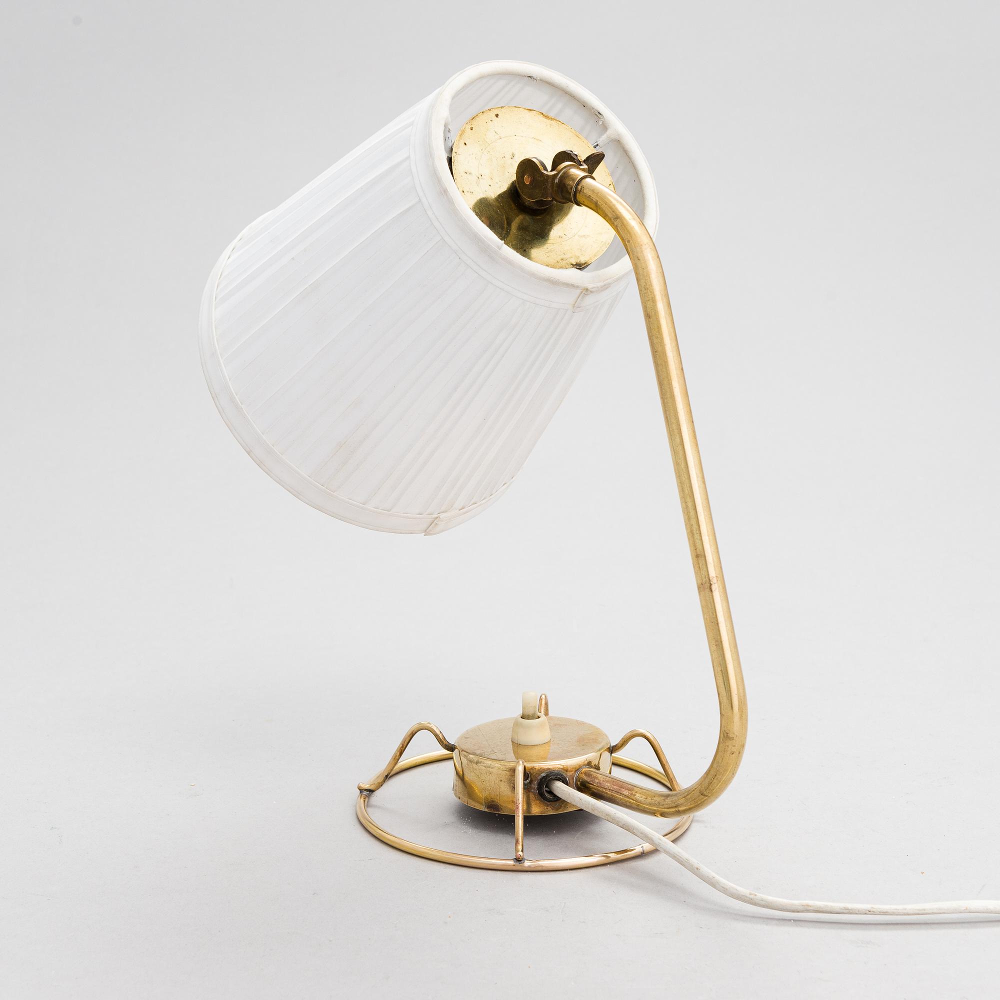 A mid-20th-century table lamp
/wall light for Idman.
