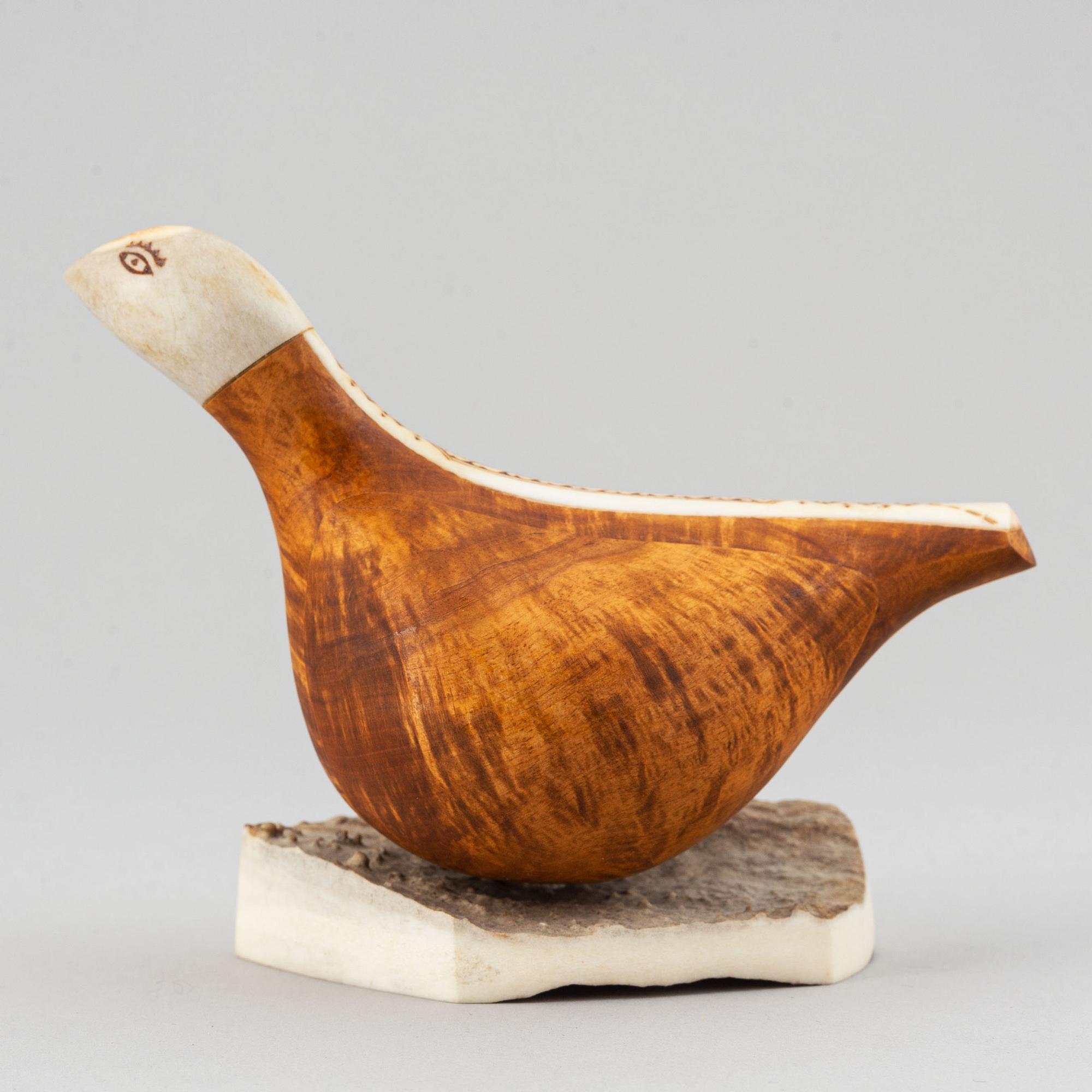 Lars Levi Sunna, a grouse reindeer horn and birch figurine, signed LL Sunna.