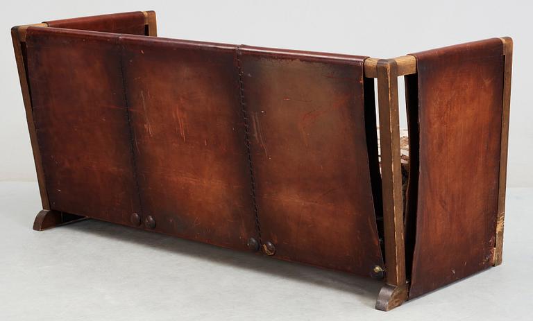 An Axel Einar Hjorth 'Funkis' brown leather and stained wood sofa, Nordiska Kompaniet, Sweden 1930's.