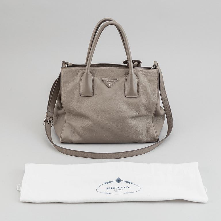 Prada, a leather handbag.