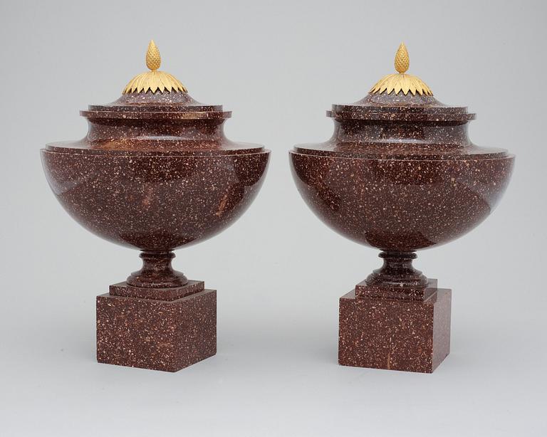 A pair of late Gustavian early 19th century porphyry urns with covers.