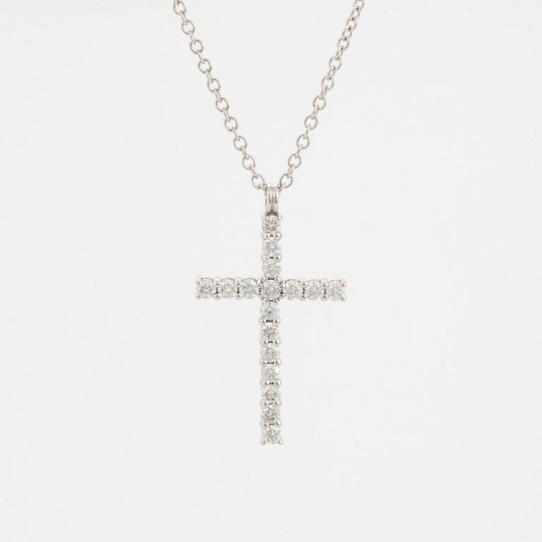 Brilliant-cut diamond cross pendant.