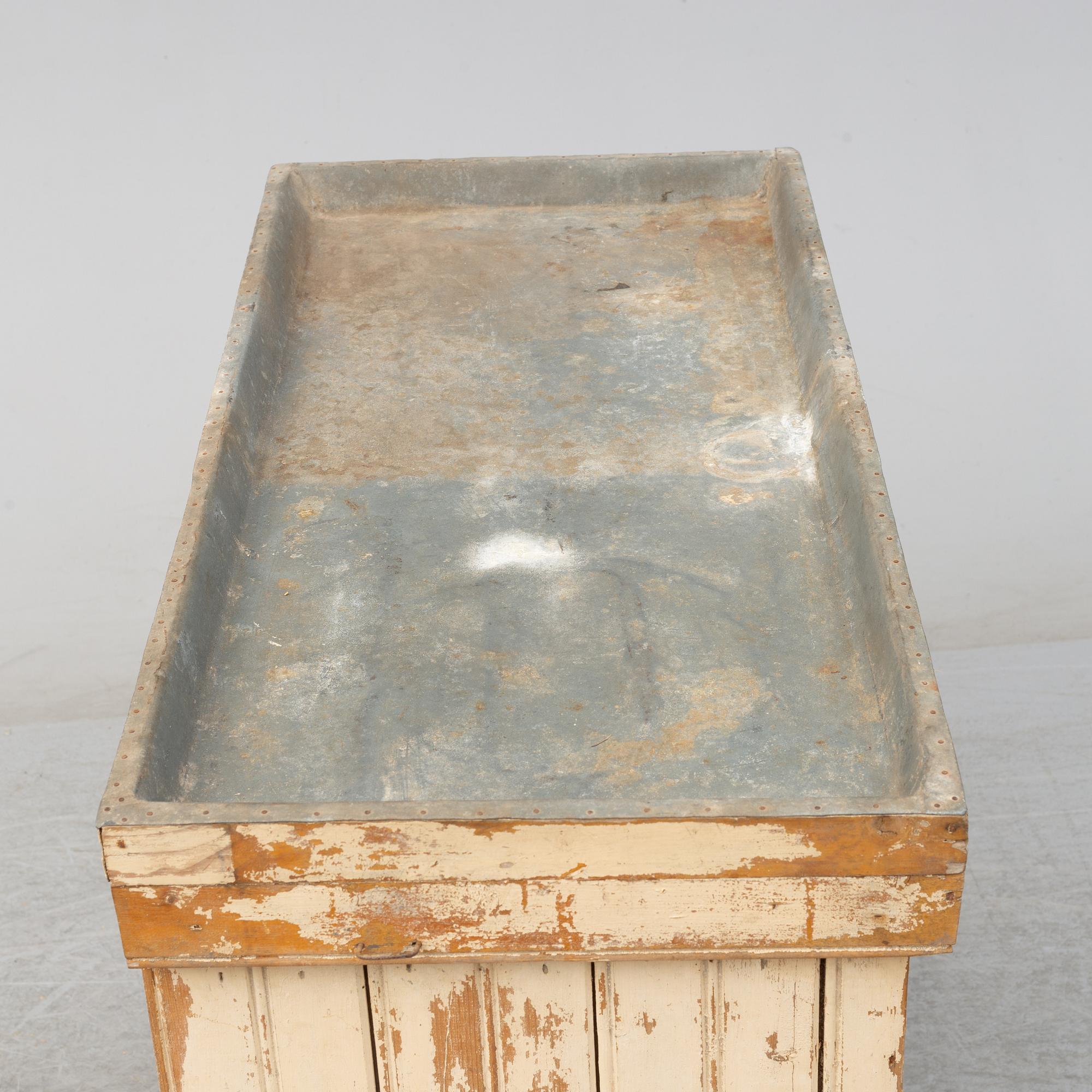 A late 19th Century cabinet with zink top.