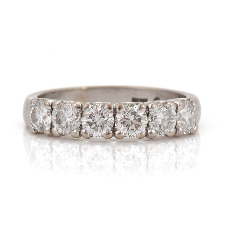 A half-eternity ring set with round, brilliant-cut diamonds.