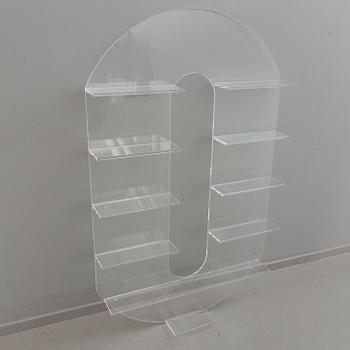 Shelf, plexi glass, in the shape of the letter 'O',Non Violence.