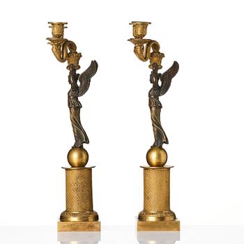 A pair of gilt and patinated bronze Empire-style two branch candelabra, later part 18th century.