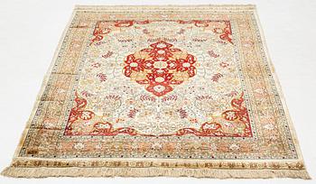 A rug, semi-antique, silke Hereke, signed, ca 184,5 x 118 cm.