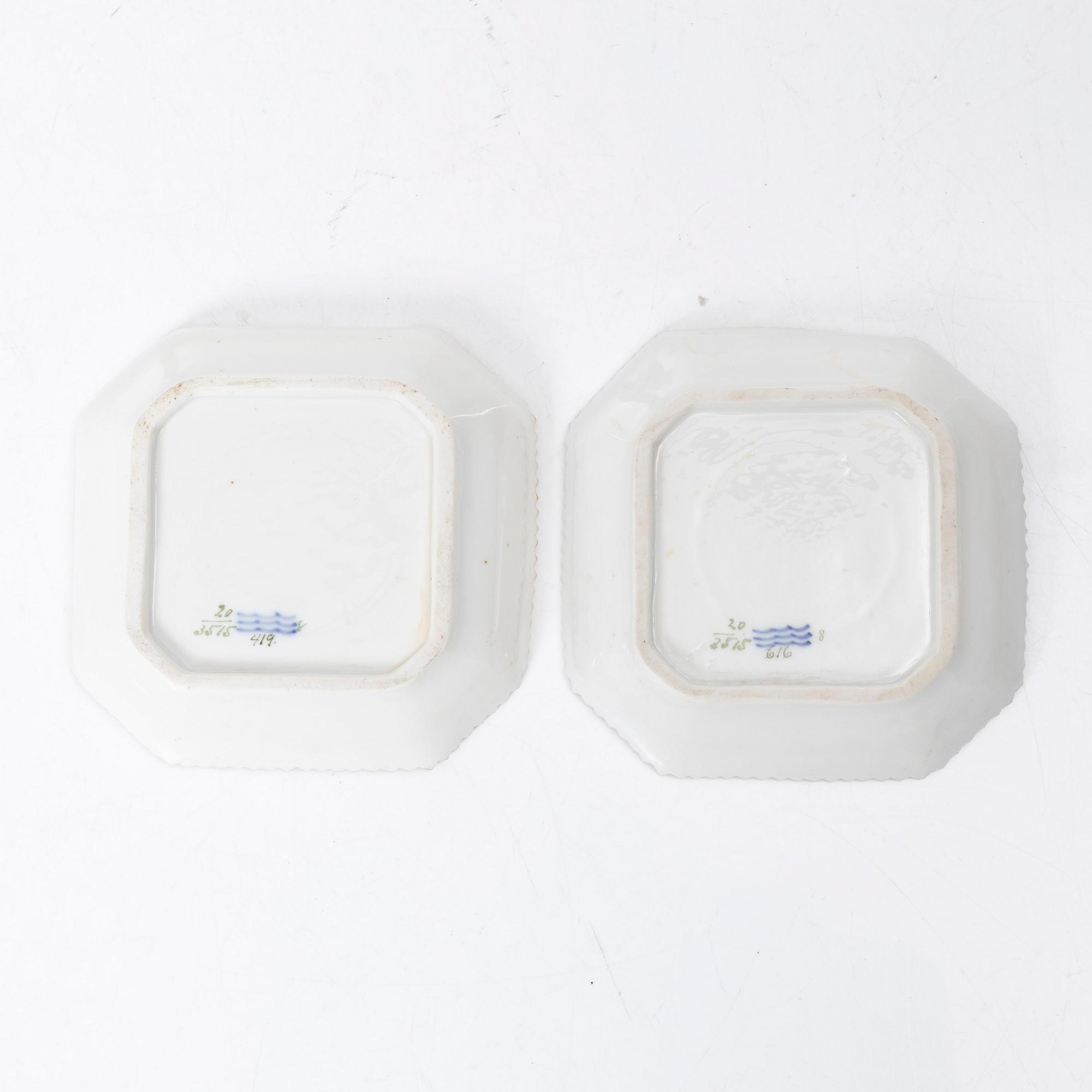 A pair of Royal Copenhagen 'Flora Danica' custard cups with covers and stands, Denmark, 20th century.