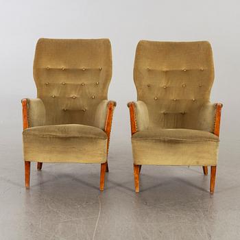 A pair of first half of the 20th century lounge chairs.