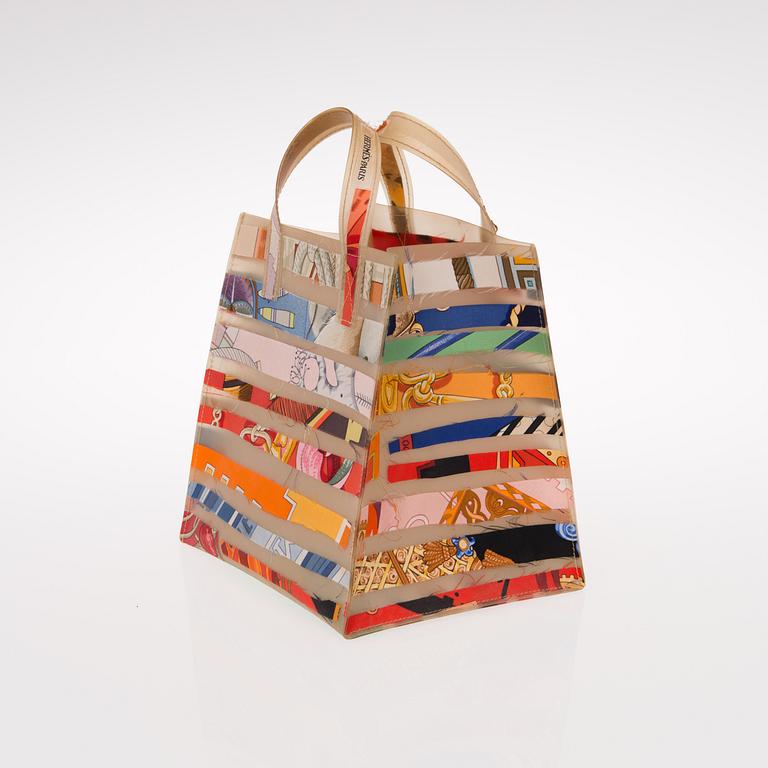 A PLASTIC AND SILK TOTE BAG.