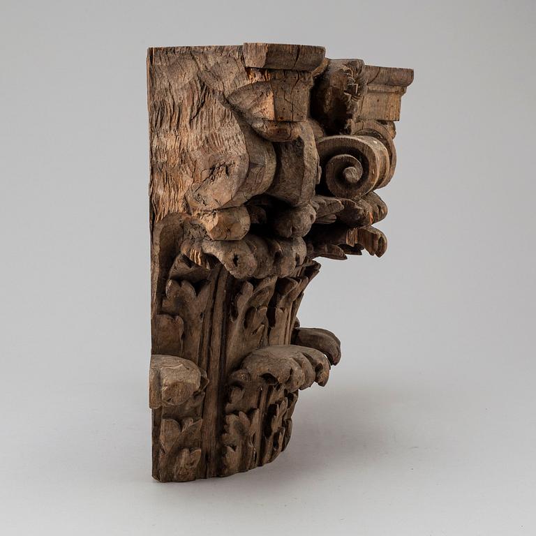 An 18th century carved wood corinthian capital.
