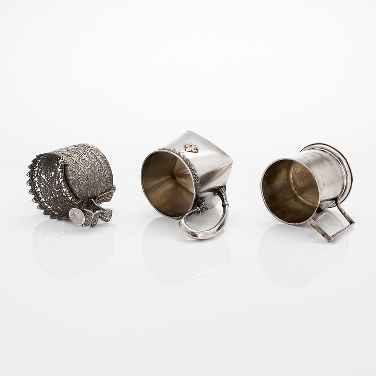 Three silver tea glass holders and four spoons, silver Kostroma and Moscow, late 19th and early 20th centuries.