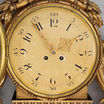 A Gustavian style wall clock, circa 1900.
