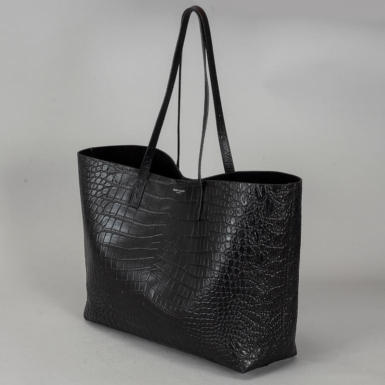YVES SAINT LAURENT, a black patent leather shopper.