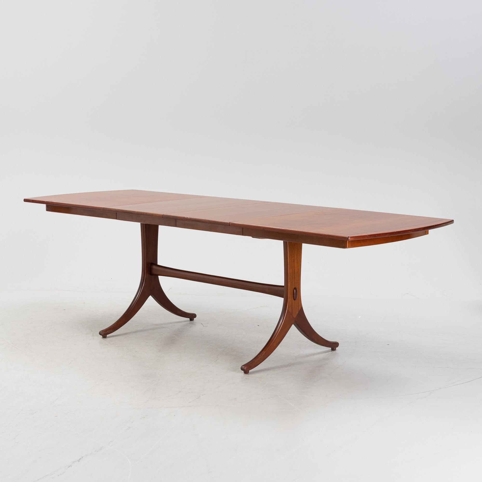 A mahogany and rosewood veneered dining table, mid 20th Century.