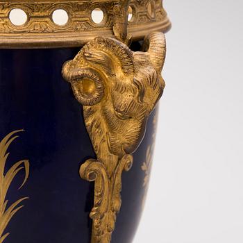 A FRENCH SÈVRES STYLE URN, porcelain and gilt bronze, latter half of the 19th century.